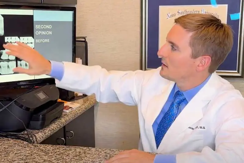 Dr. McCawley pointing a a computer screen.
