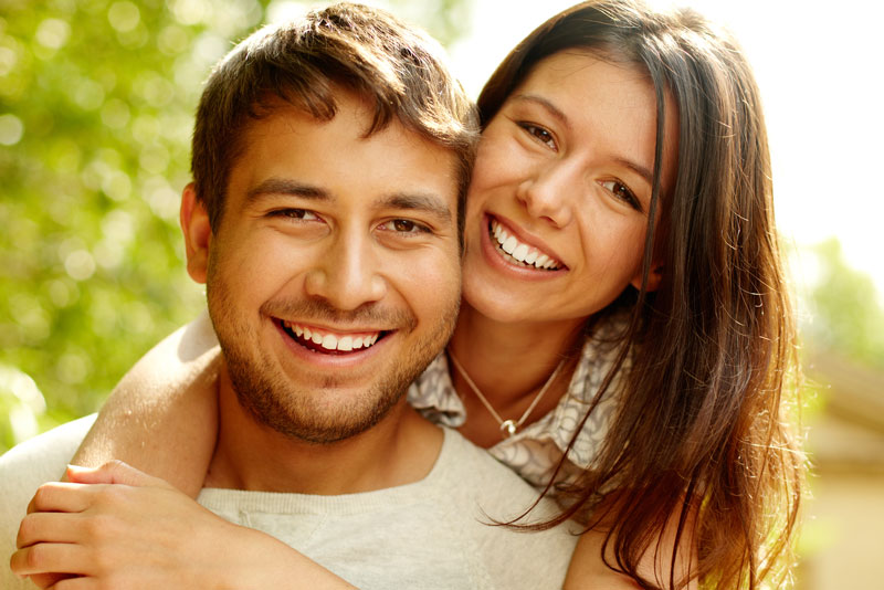 patients smiling after their dental implant procedure