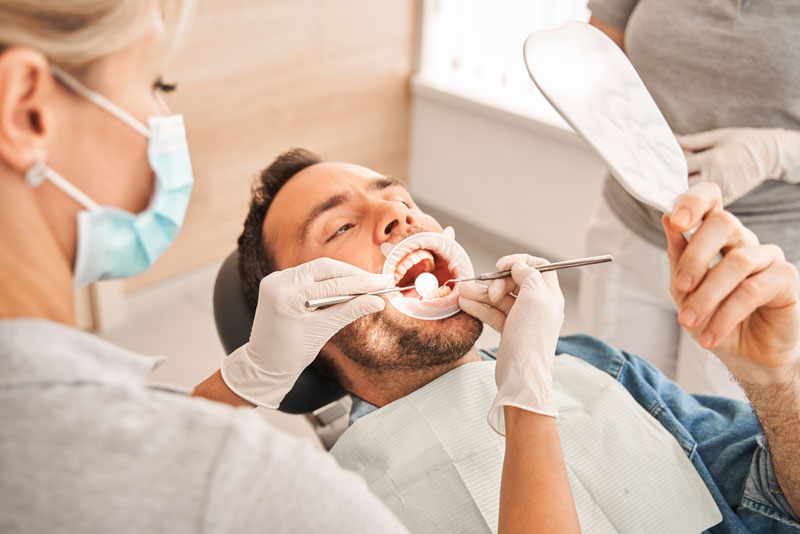 a gum disease patient being checked for periodontal disease by an expert dentist.