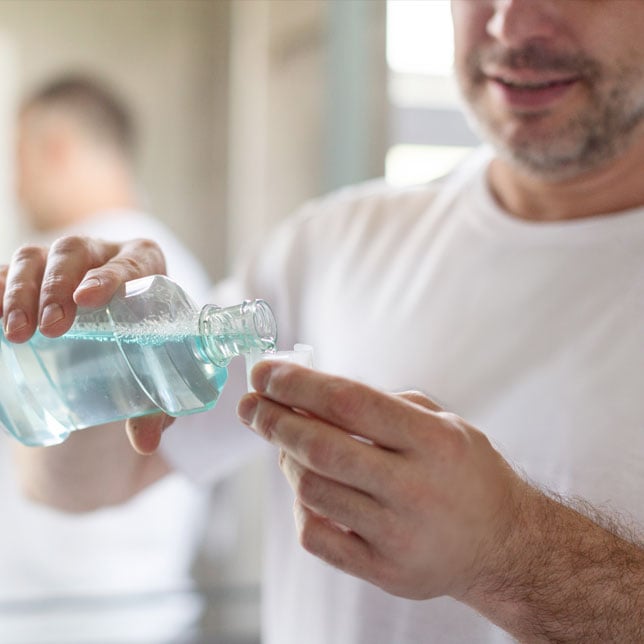 dental patient using mouthwash